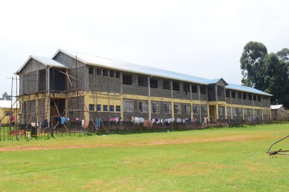 Classroom block with staff standing on the lawn