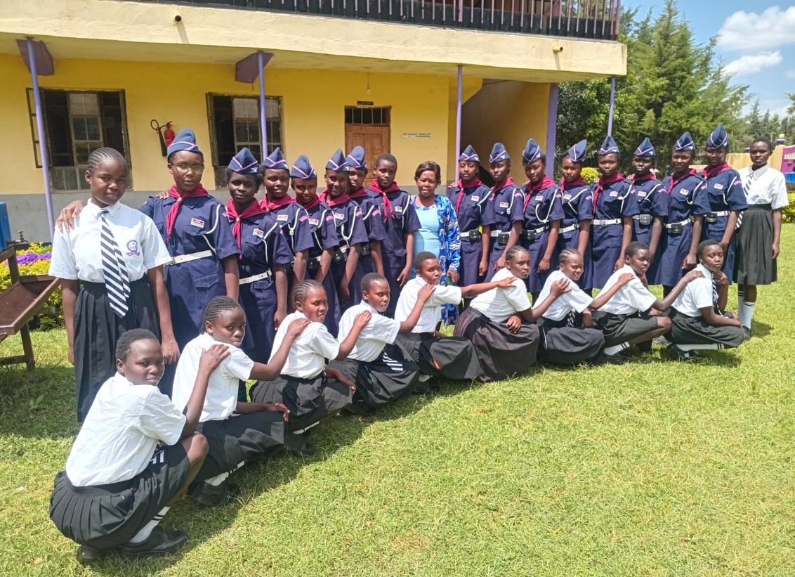 Learners seated in front of the classroom block