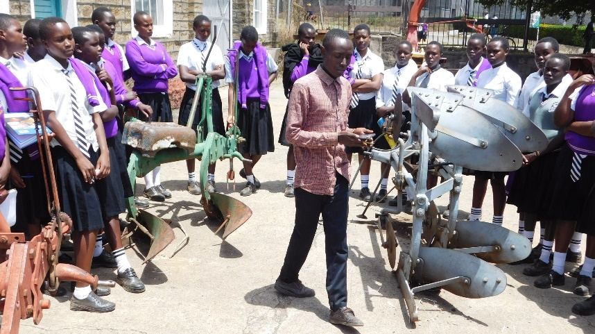 Learners and visitors viewing farm equipment