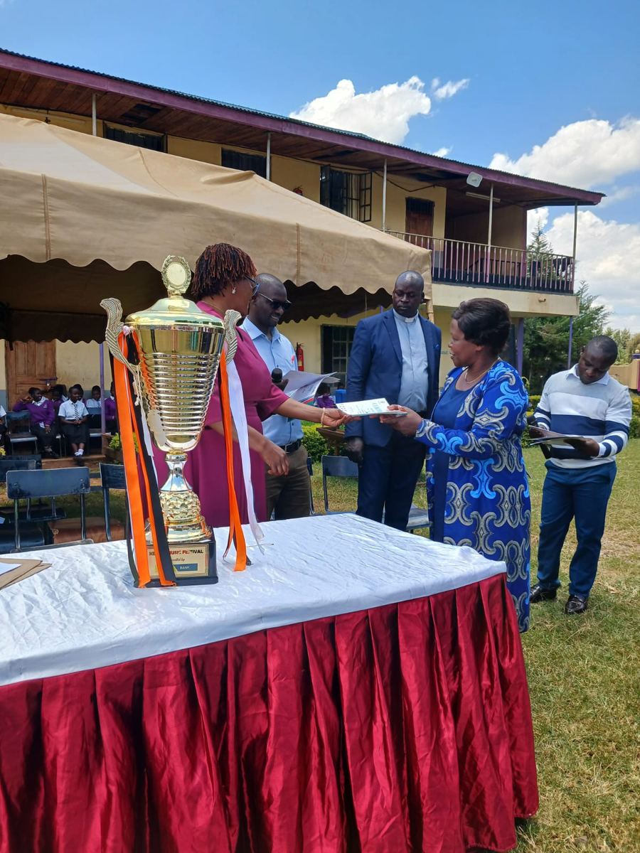 The Music Club trophy at the presentation table, with guests handing over certificates
