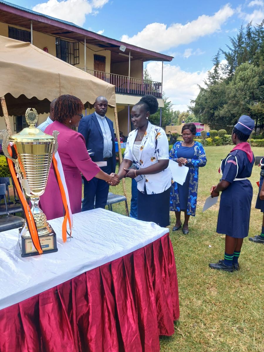 Guests congratulating one another beside the trophy